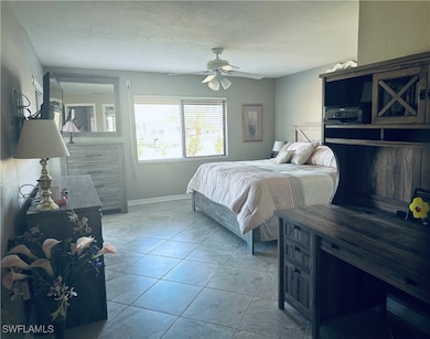 Bedroom featuring light tile patterned floors, bas