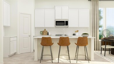 Kitchen featuring light countertops, white cabinet