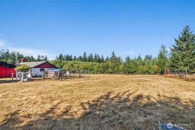 Back yard with chicken coop next to garage.