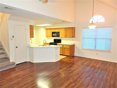 Kitchen featuring a high ceiling, dark wood-type 