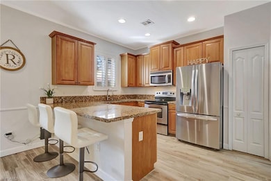 Kitchen featuring a breakfast bar, appliances with