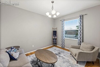 Living room with an inviting chandelier and hardwo