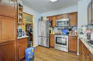 Kitchen with light hardwood / wood-style floors, l
