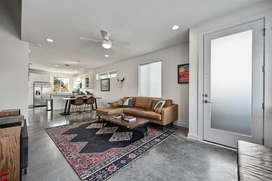 Living room with baseboards, concrete floors, cei