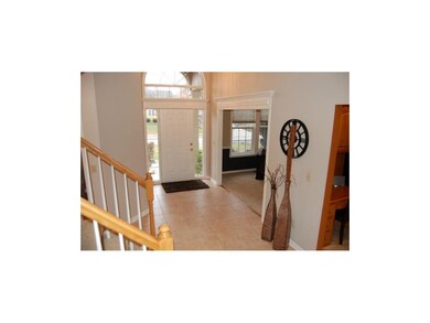 Tile entry and arched window over the front door b