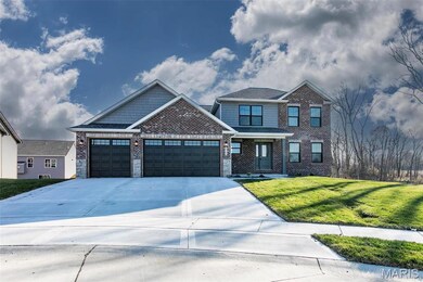 Craftsman-style house with a garage and a front lawn