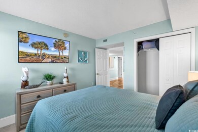 Bedroom with hardwood / wood-style floors and a cl