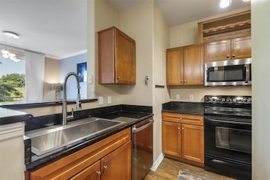 Kitchen featuring brown cabinets, stainless steel 