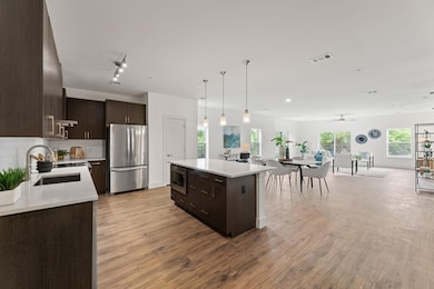 Kitchen with stainless steel appliances, dark bro