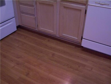 Close up of kitchen flooring and cabinetry.