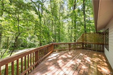 Deck runs entire width of house, overlooking backy