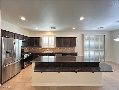 Kitchen with a sink, visible vents, backsplash, an