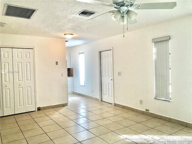 View to closet with washer and dryer to be installed, front door and entrance to kitchen