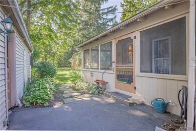 Screened in side porch, beautiful back yard