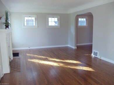 LARGE LIVING ROOM HAS AN INVITING ARCH THAT LEADS 
