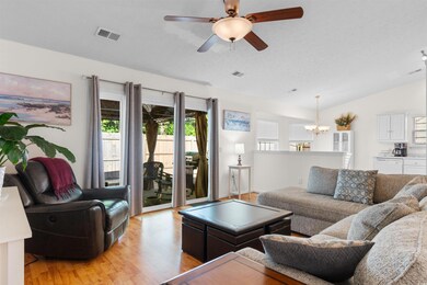 Living area featuring a chandelier, light wood fin