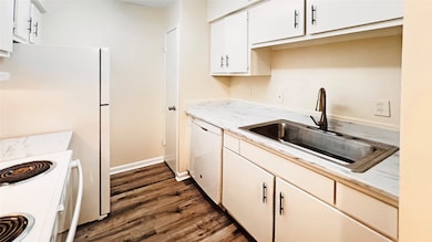 Modern kitchen boasting sleek white cabinetry, mar