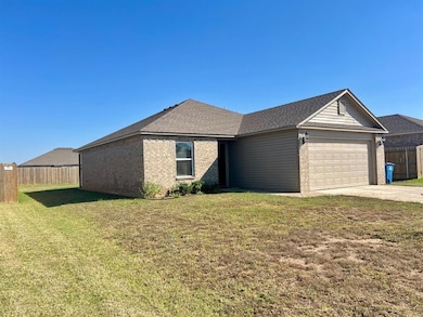 Ranch-style home featuring brick siding, concrete driveway, a garage, and roof with shingles