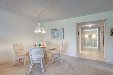 Dining room with carpet flooring and tile entryway