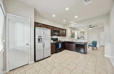 Kitchen with dark brown cabinetry, ceiling fan, a