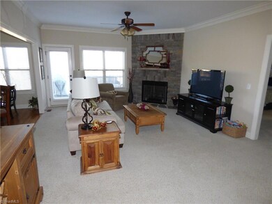 Airy living room with gorgeous stone fireplace.