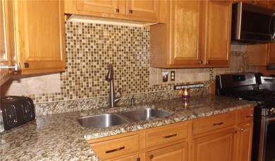 Kitchen features granite counter tops.  Stove pictured not included.  Seller will replace gas stove.