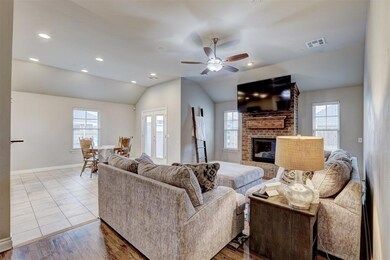 Living room featuring lofted ceiling, wood floorin