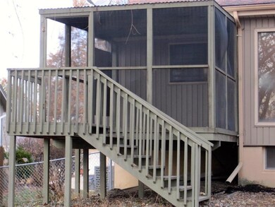 This covered, screened porch is where you retreat 