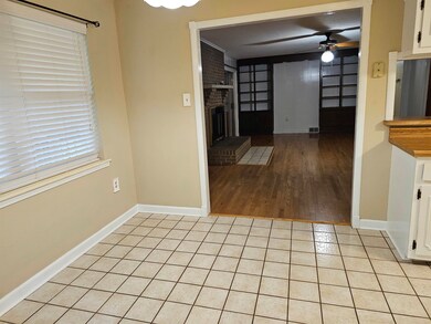Interior space with a brick fireplace, ceiling fan