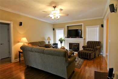 Living room offers 9' ceilings, neutral paint, hardwood floors, gas firplace w/t.v. area above, and wiring for surround sound.