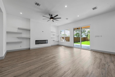 Unfurnished living room featuring built in shelves