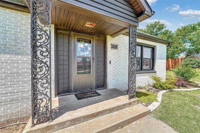 Property entrance with brick siding and fence
