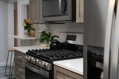 Kitchen with gray cabinets and appliances with sta
