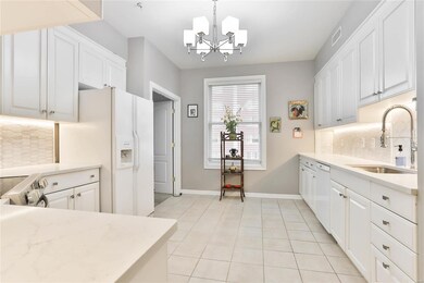 Updated kitchen includes white cabinets, quartz co