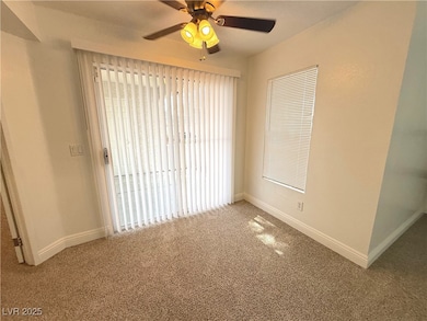Carpeted empty room with baseboards and a ceiling