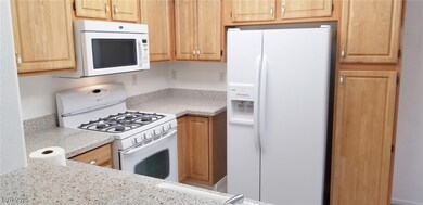 Kitchen with white appliances and light countertop