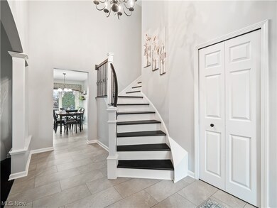 Spacious foyer with updated LVP flooring and decorative columns