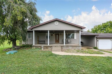 Bungalow-style home featuring garage, a porch, and