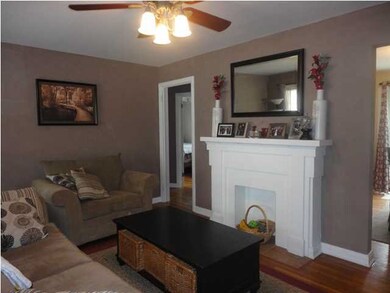 View of living room, decorative fireplace, hardwoo
