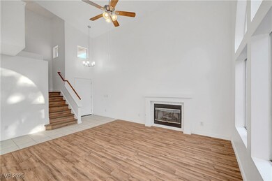Unfurnished living room featuring stairs, light wo