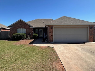 Single story home featuring brick siding, a shingled roof, and concrete driveway