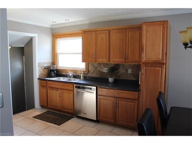 Elegant tiled backsplash, stainless steel and blac