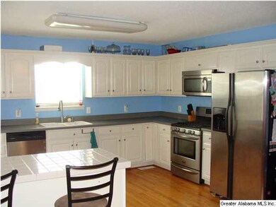 COUNTRY KITCHEN WITH HARDWOOD FLOORING...STAINLESS