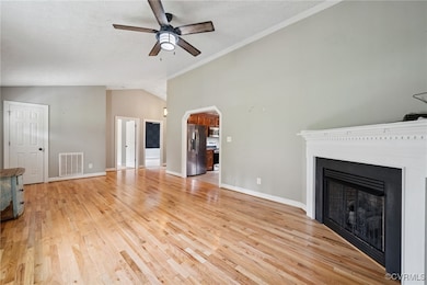 Unfurnished living room featuring lofted ceiling,