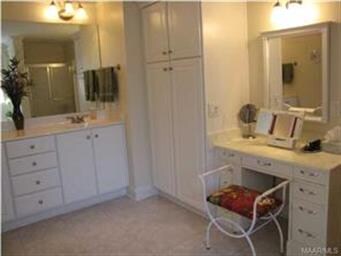 THE LUSH MASTER BATH HAS A SEATING AREA PERFECT FO