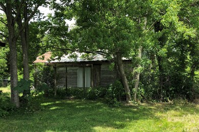 Garage behind house.