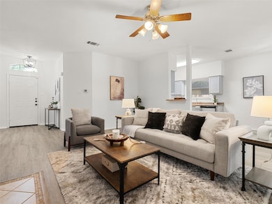 Living area with light wood-style floors, a ceili