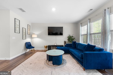 Main floor has a bright, open floorplan with a spacious living room, dining area and French doors to the outdoor garden and patio, overlooking a wooded area.