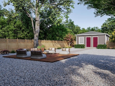 Fenced backyard with a deck and an outbuilding