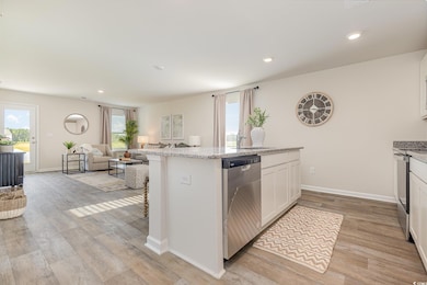 Kitchen featuring dishwasher, open floor plan, whi